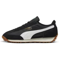 Black and white Puma trainers with suede accents, gum sole, and signature side stripe.