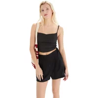 Black viscose women's shorts, loose fit, elastic waistband, paired with a black spaghetti strap top.