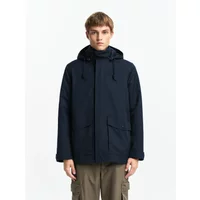 Navy blue waterproof jacket with hood, front zipper, and two large pockets, worn by a model.
