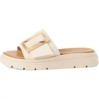 Beige wedge mules for women with a wide strap, large buckle, and textured sole by Tamaris.