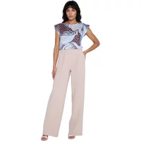 Wide-leg beige trousers with pleats, high waist, worn by a woman in a patterned top.