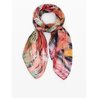 Colorful Desigual Nasau foulard with tropical floral patterns in pink, orange, green, and black tones.
