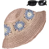 Beige crochet sun hat with blue and white floral patterns, paired with black rectangular sunglasses.