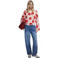 Desigual Noruega sweater with red floral pattern on white, scalloped hem, worn by model with blue jeans.