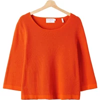Orange Holebrook Belle women's sweater with wide neckline and three-quarter sleeves on a wooden hanger.