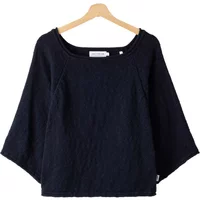 Black Holebrook Juni Boxy sweater with wide sleeves and boat neckline on a wooden hanger.