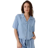 Light blue short-sleeve button-up shirt with collar and chest pocket, worn by a woman.