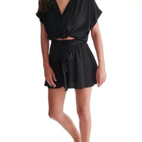 Black women’s tie waist shorts with a flowy design and elastic waistband, paired with a matching short-sleeve top.