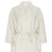 Women's 3/4 sleeve blouse in light beige with button front, collar, and waist tie by Moss Copenhagen.