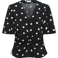 Black women's blouse with white polka dots, V-neck, short sleeves, and gathered front detail.