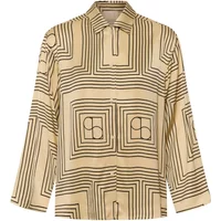 Beige women's blouse with geometric black square patterns and long sleeves by Soaked in Luxury.