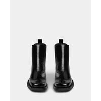 Black leather ankle boots with a glossy finish, rounded toe, and pull tabs by Sofie Schnoor.