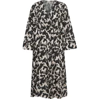 Black and white patterned women's dress with long sleeves and a V-neckline.