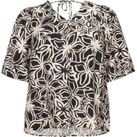 Black and white floral flared blouse with V-neck and tie-back detail, short sleeves by KAFFE Curve Haliah.