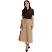 Beige flared midi skirt by Greenpoint, worn with a dark short-sleeve top and black heels.