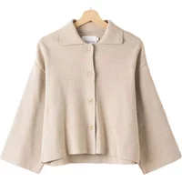 Beige Holebrook Jane women's jacket with wide sleeves, button-up front, and a flat collar on a wooden hanger.