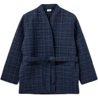 Navy blue quilted women's jacket by Sofie Schnoor with a grid pattern, belted waist, and long sleeves.