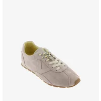 White lace-up trainers with beige sole, subtle side logo, and stitched detailing by Victoria Aster.