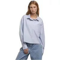 Light blue women's long sleeve Oxford shirt with a classic collar and button-down front, worn by a model with jeans.