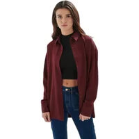 Burgundy women's oversize shirt by 24 Colours, long sleeves, button-up, worn over black crop top and jeans.