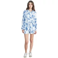 White and blue floral printed women's casual shorts with matching long-sleeve top, worn by a model with sneakers.