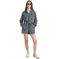 Women's black shorts with white polka dots, elastic waistband, paired with matching top.