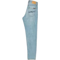 Women's light blue Nudie Jeans Breezy Britt with back pocket stitching and tan leather patch.