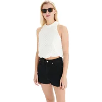 White round-neck tank top with textured fabric, sleeveless design, worn by a model with black shorts.