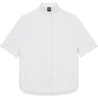 White women's sleeveless linen shirt by Colmar with a mandarin collar and button-down front.