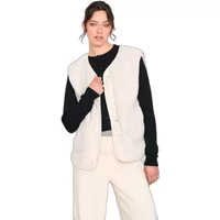 Sleeveless white teddy fleece vest, buttoned front, worn over black long-sleeve top and cream pants.