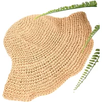 Women's straw hat by 24 Colours, natural woven texture, wide brim, adorned with green fern leaves.