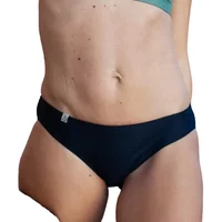 Women's black swimsuit bottoms, classic cut, smooth fabric, subtle side tag, paired with a green top.