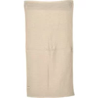 Cream-colored women's towel Nou Rosalinda with subtle ribbed texture and small embroidered logo at the corner.