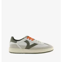 White and olive women's trainers with orange laces, suede accents, and a thick sole.