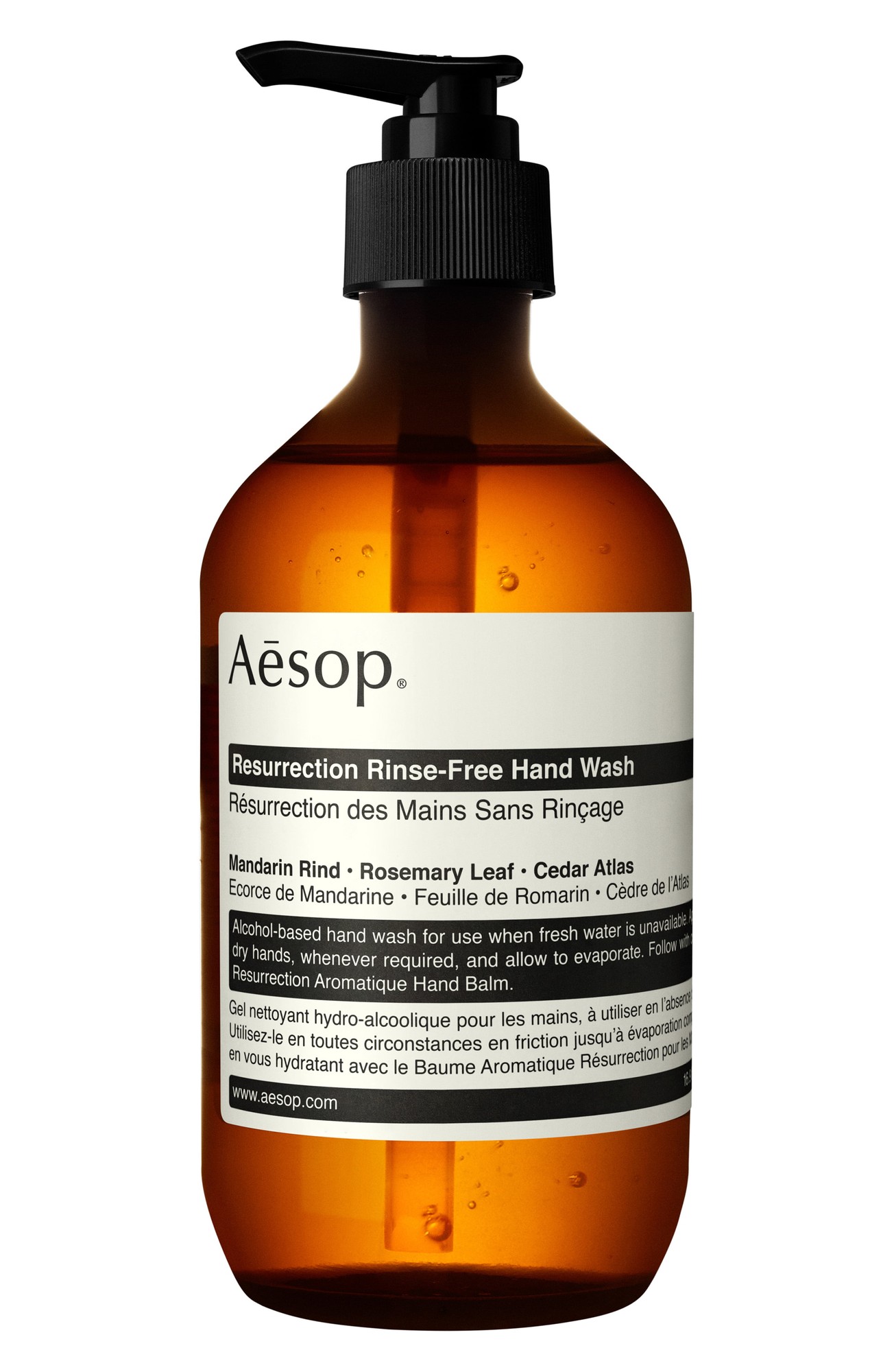 Amber glass bottle with a black pump, labeled "Aesop - Resurrection Rinse-Free Hand Wash," featuring a white and black text design highlighting key ingredients like mandarin rind and rosemary leaf.
