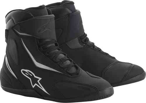 Black and white Alpinestars Fastback 2 Drystar CE motorcycle boots, featuring a sleek design, lace-up front, and padded ankle support, size US 7/EU 39.