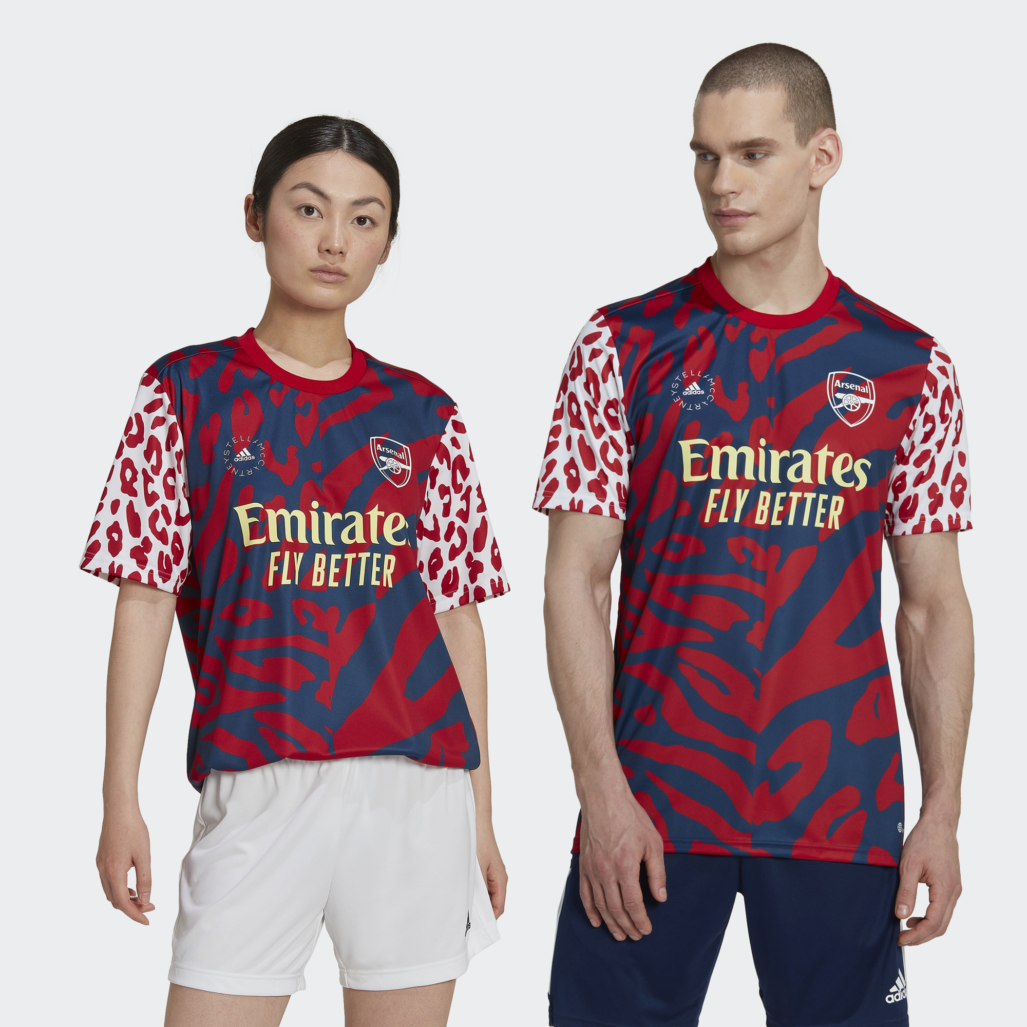 Scarlet pre-match jersey featuring a bold leopard print design, short sleeves, and "Emirates Fly Better" logo, made from lightweight material, size 2XL.