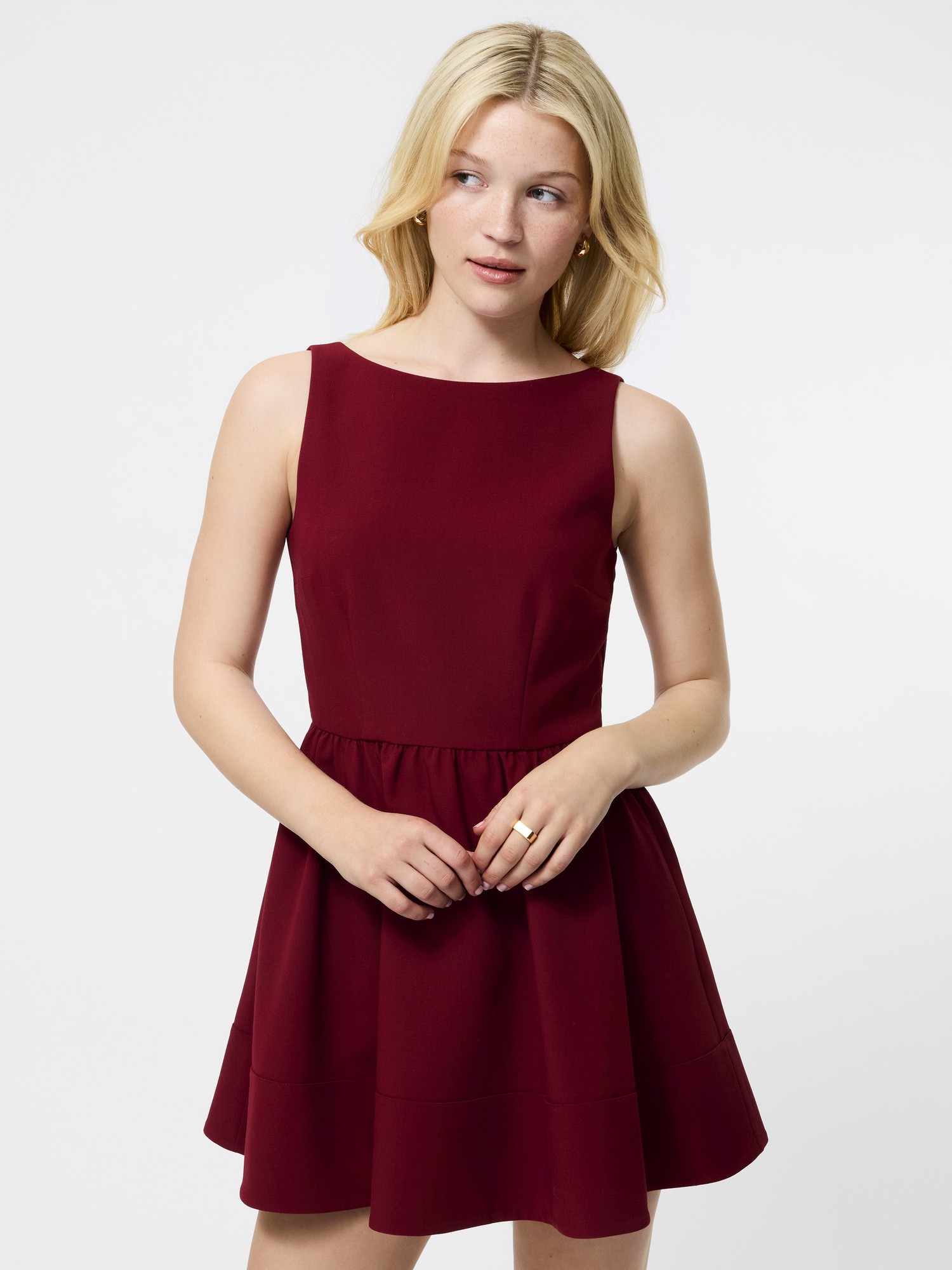 Cabernet red fit and flare mini dress with a low back, featuring a sleeveless design and a gathered waist for a flattering silhouette.