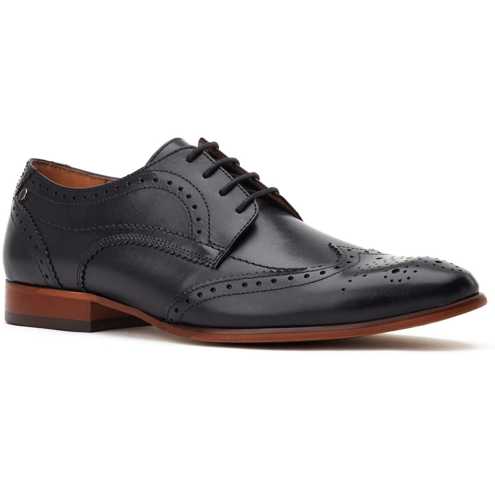 Black leather brogue shoes featuring decorative perforations, a classic lace-up design, and a contrasting brown leather sole for a stylish finish.