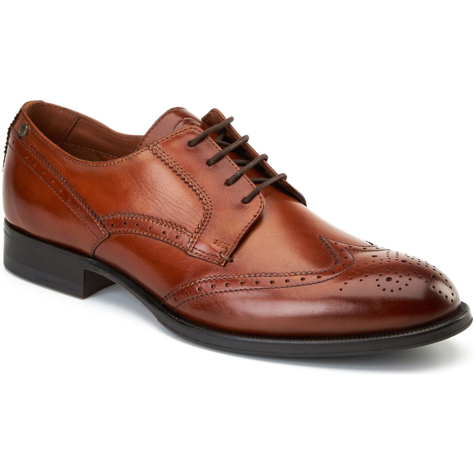 Burnt tan leather brogues featuring intricate perforations, a classic lace-up design, and a sleek black sole, showcasing a sophisticated and stylish appearance.