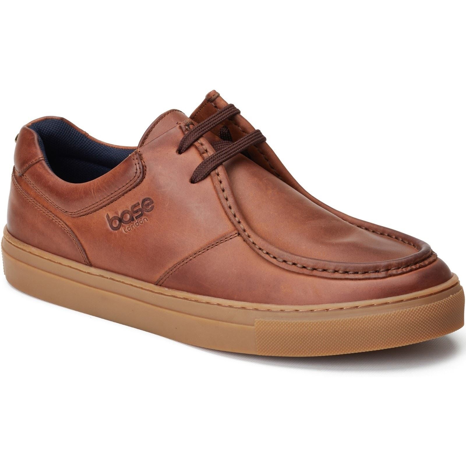 Brown leather moccasin shoes with a rounded toe, stitched detailing, and a rubber sole, featuring a lace-up design and a subtle logo on the side.