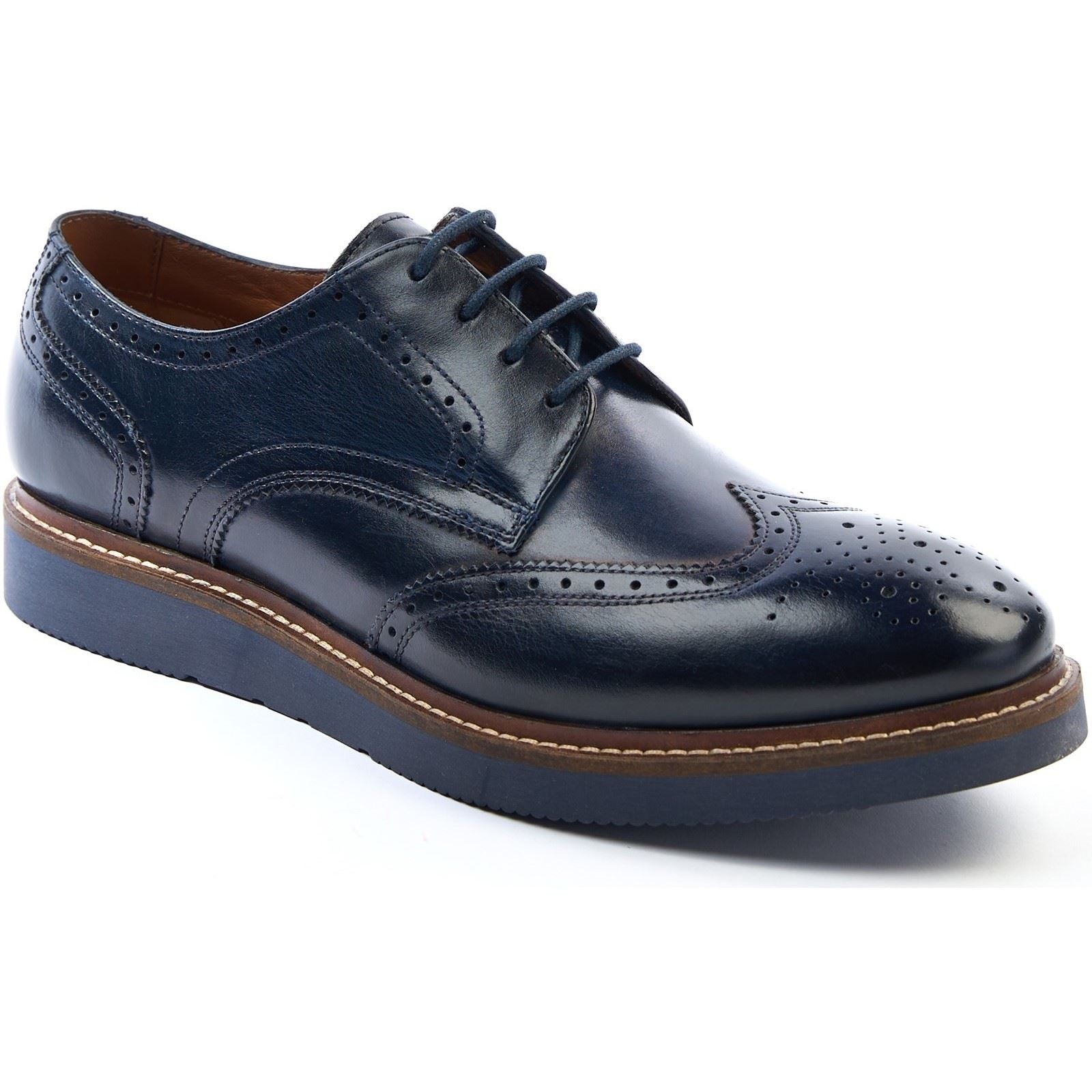 Navy leather brogues with decorative perforations, featuring a rounded toe, lace-up closure, and a contrasting brown sole for added style.