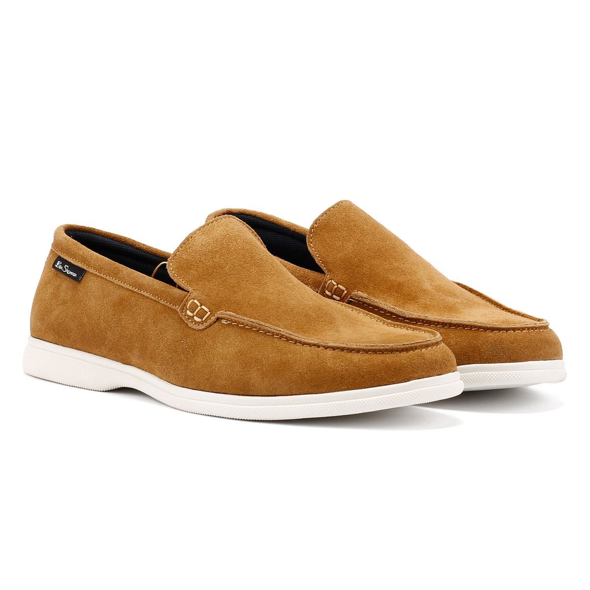 Tan suede slip-on shoes with a smooth finish, featuring a stitched detail and a white rubber sole, labeled with the Ben Sherman logo. Size 7.