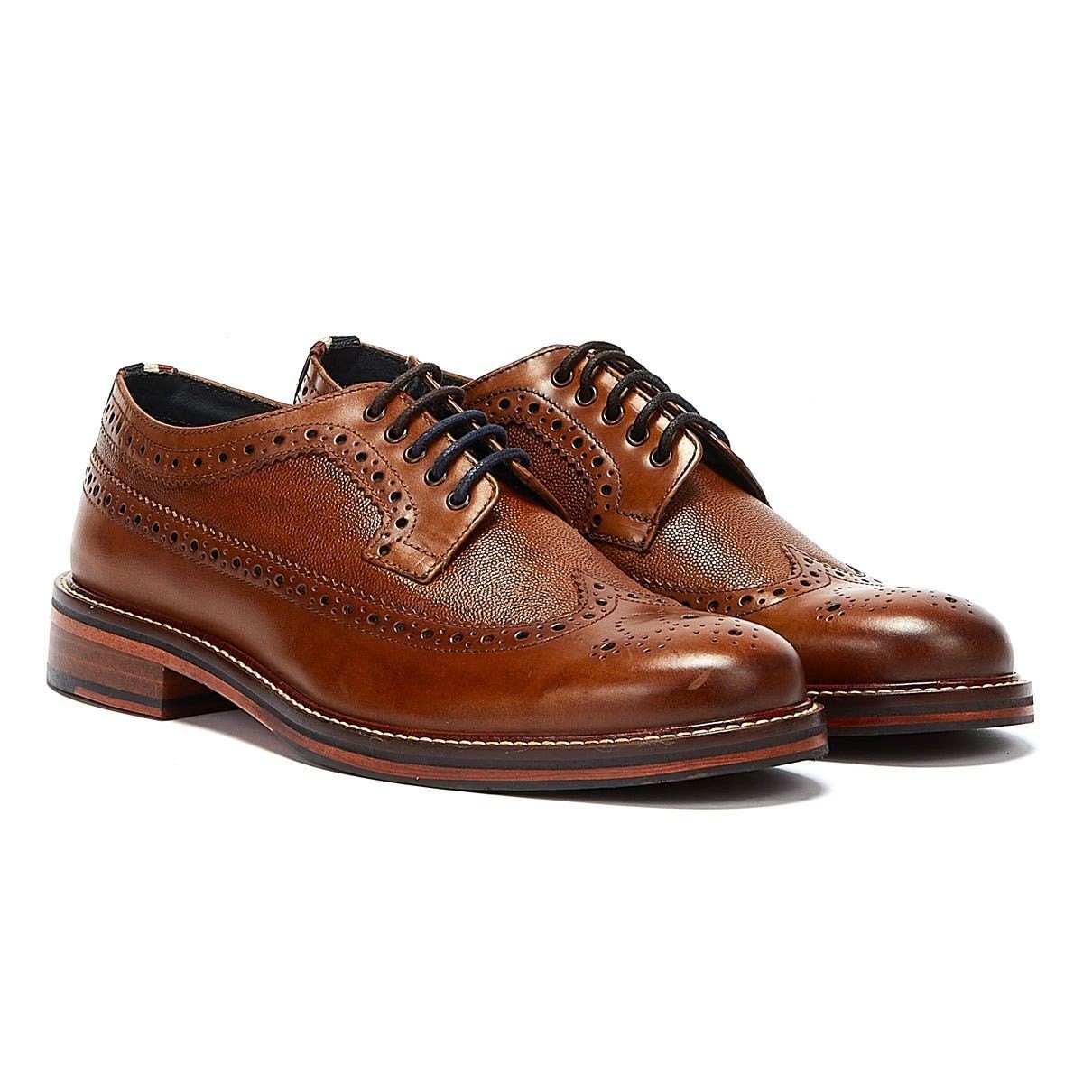 Tan leather lace-up shoes featuring brogue detailing, perforations, and a sturdy wooden sole, designed for men by Ben Sherman.