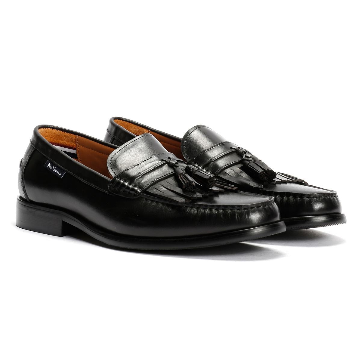 Black leather loafers featuring a classic design with tassels and a sleek, polished finish, ideal for formal or smart-casual occasions.