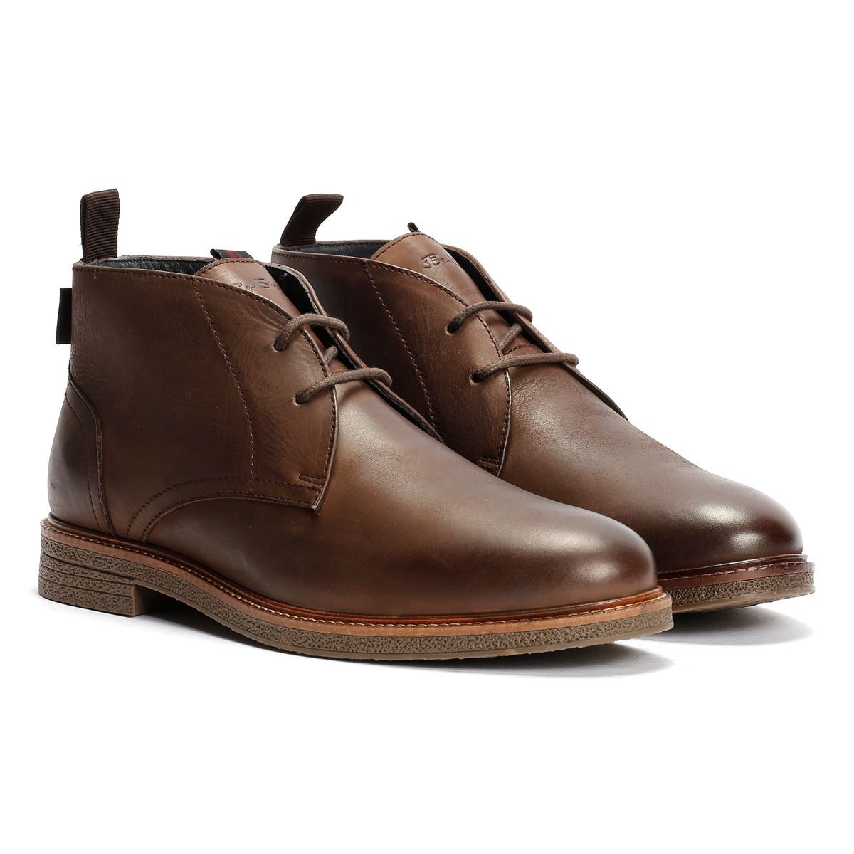 Brown leather chukka boots featuring a smooth finish, lace-up design, and a contrasting textured sole, ideal for casual or smart-casual wear.