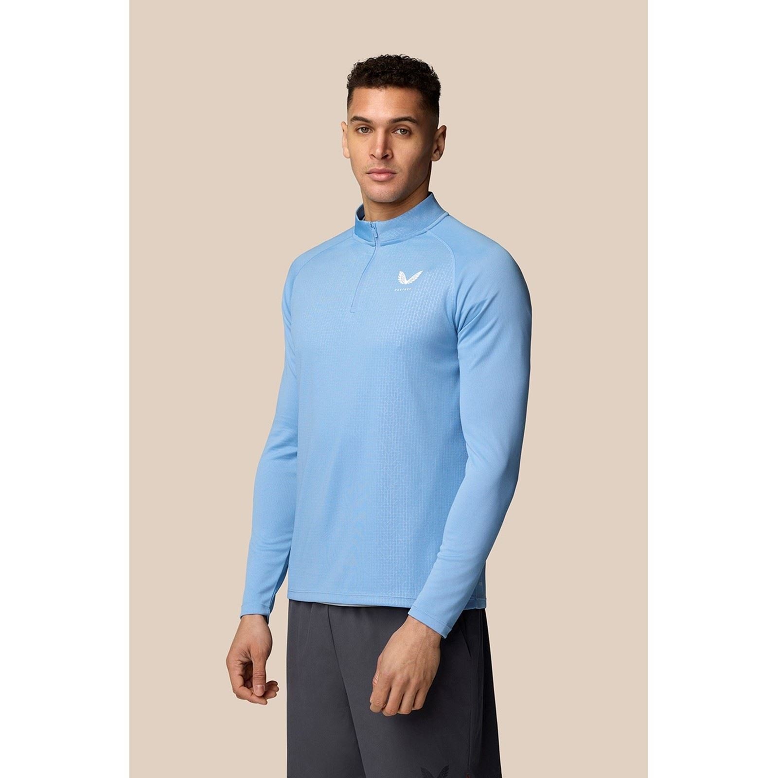 Men's black 1/4 zip top made of polyester, featuring a high collar, long sleeves, and a subtle logo on the chest, designed for comfort and performance.