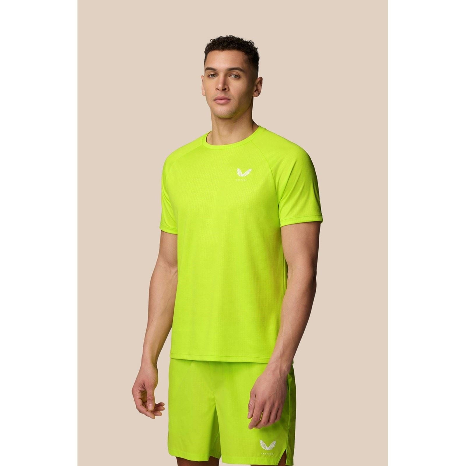 Bright green polyester activewear t-shirt for men, featuring a crew neck, short sleeves, and a subtle logo on the chest, designed for comfort and performance.