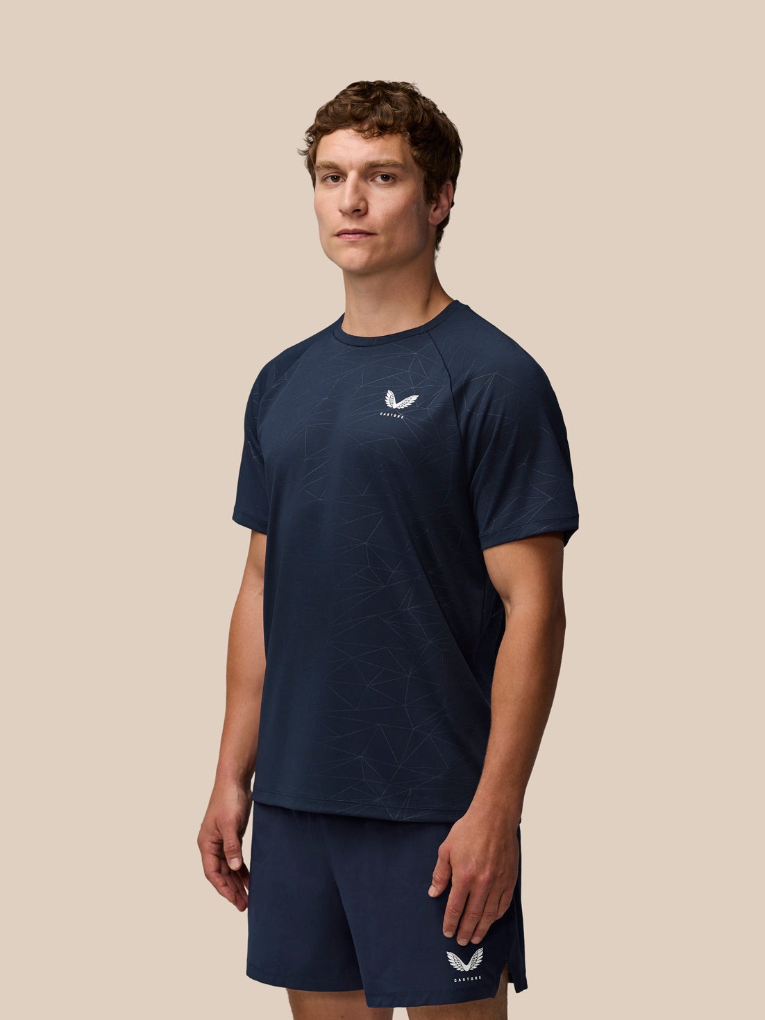 Men's blue polyester training t-shirt by Castore, featuring a crew neck, short sleeves, and a geometric pattern, designed for activewear.