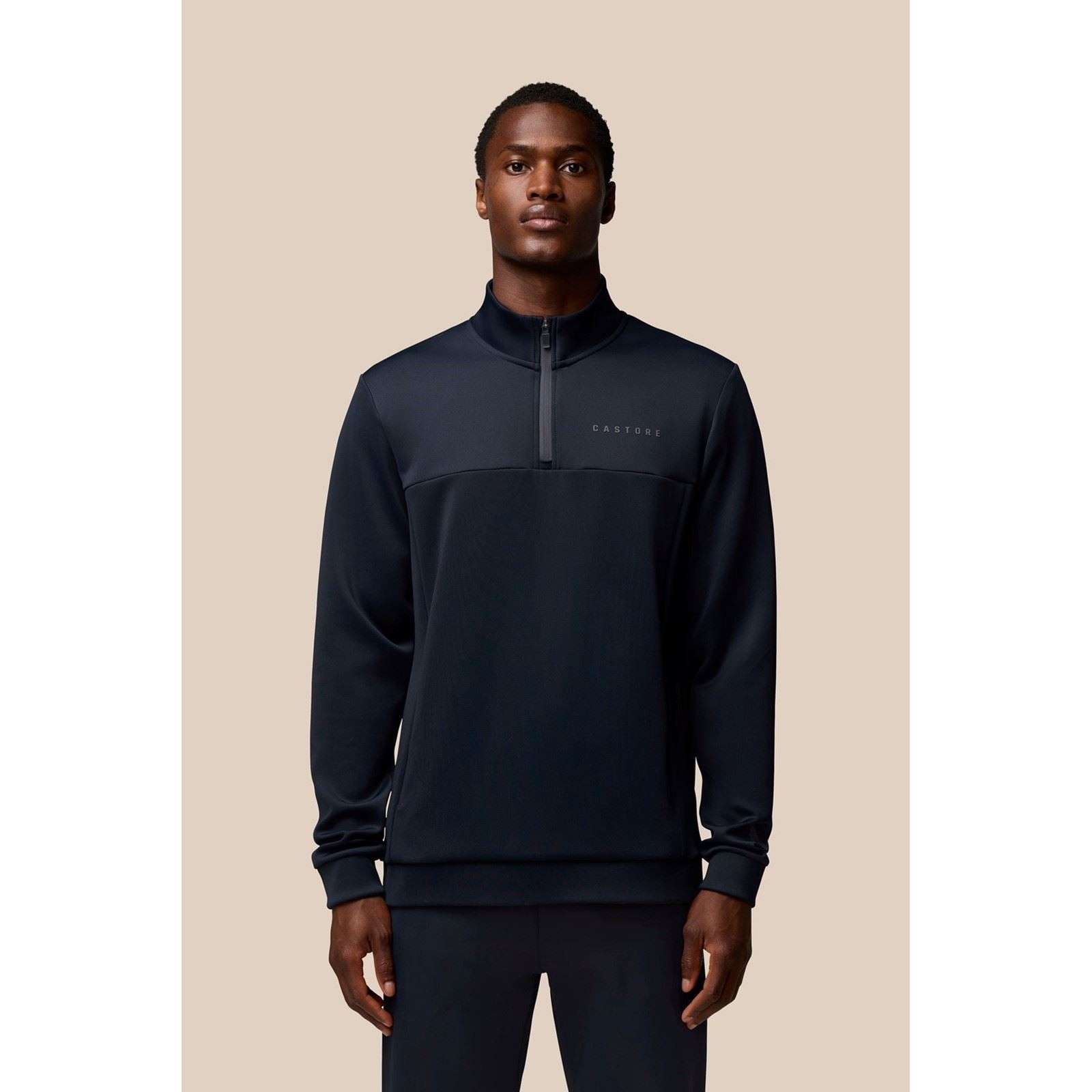 Men's blue Castore Scuba 1/4 zip sweatshirt made of polyester, featuring a high collar, a front zip, and a subtle logo on the chest.